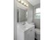 Bathroom featuring vanity, chrome fixtures, and a well-lit mirror at 7625 Marechal Ave, Port Richey, FL 34668