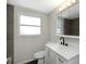 This bathroom features a white cabinet and a dark faucet at 7625 Marechal Ave, Port Richey, FL 34668