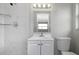 Bathroom featuring marble tile and floating shelves at 7625 Marechal Ave, Port Richey, FL 34668