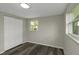 This bedroom features wood floors, a window, and closet at 7625 Marechal Ave, Port Richey, FL 34668
