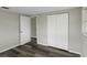 This bedroom features wood floors and a closet at 7625 Marechal Ave, Port Richey, FL 34668