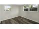 Bedroom features neutral walls and gray wood flooring at 7625 Marechal Ave, Port Richey, FL 34668