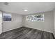 Bright bedroom featuring wood-look floors and double-paned windows offering plenty of natural light at 7625 Marechal Ave, Port Richey, FL 34668