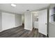 This bedroom features wood floors, a closet, and leads into a bathroom at 7625 Marechal Ave, Port Richey, FL 34668