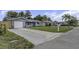Single-story home with gray exterior, driveway, and a manicured front lawn at 7625 Marechal Ave, Port Richey, FL 34668