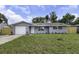 Charming single-story home featuring a gray exterior, well-maintained lawn, and attached garage at 7625 Marechal Ave, Port Richey, FL 34668