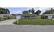 Exterior of a single-story house with a well-kept lawn and an attached garage at 7625 Marechal Ave, Port Richey, FL 34668