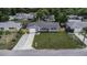 Aerial view of well-maintained home with a landscaped lawn and long driveway at 7625 Marechal Ave, Port Richey, FL 34668