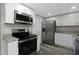 Updated kitchen featuring stainless steel appliances and white cabinets at 7625 Marechal Ave, Port Richey, FL 34668