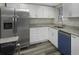Charming kitchen with stainless steel appliances, granite countertops, and white cabinetry at 7625 Marechal Ave, Port Richey, FL 34668