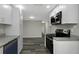 Modern kitchen featuring granite countertops, stainless steel appliances, and white cabinets at 7625 Marechal Ave, Port Richey, FL 34668