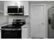 Updated kitchen with stainless steel appliances and white cabinets at 7625 Marechal Ave, Port Richey, FL 34668