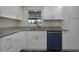 Modern kitchen featuring granite countertops, and stylish white cabinets at 7625 Marechal Ave, Port Richey, FL 34668