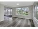 Bright and airy living room with seamless access to an enclosed outdoor patio at 7625 Marechal Ave, Port Richey, FL 34668