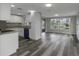 Living room with modern flooring, white cabinetry, and abundant natural light at 7625 Marechal Ave, Port Richey, FL 34668