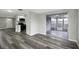 Open-concept living space boasts modern gray flooring and stainless steel kitchen appliances at 7625 Marechal Ave, Port Richey, FL 34668