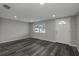 Living room featuring contemporary flooring, natural light, and a view of the front yard at 7625 Marechal Ave, Port Richey, FL 34668