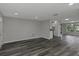 Open-concept living area with modern flooring and a seamless flow to the kitchen at 7625 Marechal Ave, Port Richey, FL 34668