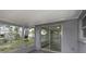 View of backyard from screened-in porch, with sliding doors to the interior at 7625 Marechal Ave, Port Richey, FL 34668