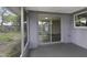 View of screened porch with sliding glass doors leading to the interior with view of the backyard at 7625 Marechal Ave, Port Richey, FL 34668