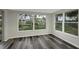 Bright sunroom surrounded by large windows offering serene backyard views at 7625 Marechal Ave, Port Richey, FL 34668