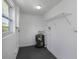 Utility room featuring water heater, storage shelving and window at 7625 Marechal Ave, Port Richey, FL 34668