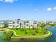 Beautiful condo buildings surrounded by lush green lawns and serene water views at 7892 Sailboat Key S Blvd # 408, South Pasadena, FL 33707