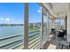 Lovely balcony view featuring waterfront views and outdoor seating with fan above at 7892 Sailboat Key S Blvd # 408, South Pasadena, FL 33707