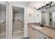 Bathroom featuring granite countertop, white cabinets, and stand-up shower with sliding glass door at 7892 Sailboat Key S Blvd # 408, South Pasadena, FL 33707