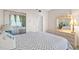 Bedroom featuring neutral paint, sliding mirrored closet, and dresser with a decorative lamp at 7892 Sailboat Key S Blvd # 408, South Pasadena, FL 33707