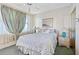 Bedroom featuring a queen bed, soft green walls, ceiling fan, and decorative curtains at 7892 Sailboat Key S Blvd # 408, South Pasadena, FL 33707