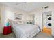 Bedroom featuring ceiling fan, view to in-unit washer/dryer, and closet with mirrored doors at 7892 Sailboat Key S Blvd # 408, South Pasadena, FL 33707