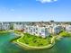Waterfront condo with lush lawn, walking path, palms, and serene water views at 7892 Sailboat Key S Blvd # 408, South Pasadena, FL 33707