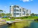 Stunning waterfront condo building with lush landscaping, private dock, and bay views at 7892 Sailboat Key S Blvd # 408, South Pasadena, FL 33707