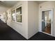 Hallway view featuring tile floors, an exterior view window, and a glass front door at 7892 Sailboat Key S Blvd # 408, South Pasadena, FL 33707