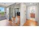 Hallway with a sliding mirror closet, a view to the outside balcony, and an adjacent bathroom at 7892 Sailboat Key S Blvd # 408, South Pasadena, FL 33707