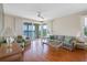 Bright living room featuring wood floors, neutral paint, and sliding doors with waterfront views at 7892 Sailboat Key S Blvd # 408, South Pasadena, FL 33707