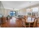 Inviting living and dining area with wood floors and sliding glass doors with water views at 7892 Sailboat Key S Blvd # 408, South Pasadena, FL 33707