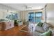 Bright living room featuring a waterfront view from a private balcony and comfortable seating arrangements at 7892 Sailboat Key S Blvd # 408, South Pasadena, FL 33707