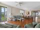 Open living room adjacent to the balcony showcasing natural light, traditional furnishings, and an adjacent dining area at 7892 Sailboat Key S Blvd # 408, South Pasadena, FL 33707