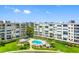 Community pool and well-manicured landscaping among the condo buildings at 7892 Sailboat Key S Blvd # 408, South Pasadena, FL 33707