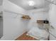 Walk-in closet with white walls, wood floors, wire shelving, and hanging clothes at 7892 Sailboat Key S Blvd # 408, South Pasadena, FL 33707