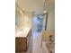 Well-lit bathroom featuring a vanity with a decorative mirror and a glimpse of an adjacent room at 8300 Bardmoor Blvd # 110, Seminole, FL 33777