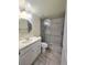 Bathroom featuring a glass-enclosed shower with decorative tile accents and a vanity sink at 8300 Bardmoor Blvd # 110, Seminole, FL 33777