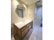 Bathroom vanity with a white countertop, wood cabinet, and an ornate mirror reflecting the doorway at 8300 Bardmoor Blvd # 110, Seminole, FL 33777