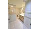 Bathroom featuring white tiled floors, glass-enclosed shower, and wooden vanity at 8300 Bardmoor Blvd # 110, Seminole, FL 33777