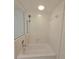 Clean, white bathtub with tiled walls and a shower head, perfect for a relaxing bath at 8300 Bardmoor Blvd # 110, Seminole, FL 33777