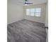 Bedroom with ceiling fan, large window and modern flooring at 8300 Bardmoor Blvd # 110, Seminole, FL 33777