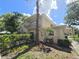 Multi-story home with a balcony, complemented by mature trees, lush landscaping, and a clear blue sky at 8300 Bardmoor Blvd # 110, Seminole, FL 33777