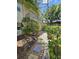 Charming townhouse exterior with a small balcony, surrounded by mature trees and manicured landscaping at 8300 Bardmoor Blvd # 110, Seminole, FL 33777